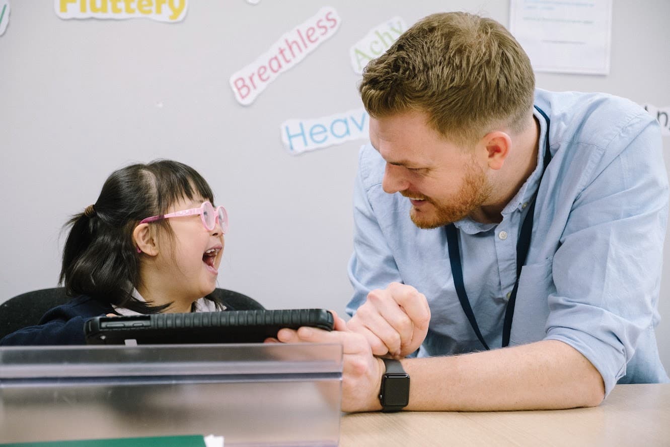 A person using assistive technology with support from Access Technology